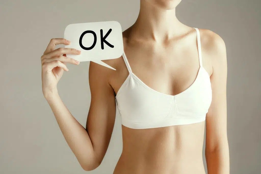 woman-health-female-model-holding-card-near-breast-young-adult-girl-with-paper-positive-symbol-ok-isolated-gray-background_155003-32139-1024x683-ezgif.com-webp-to-jpg-converter